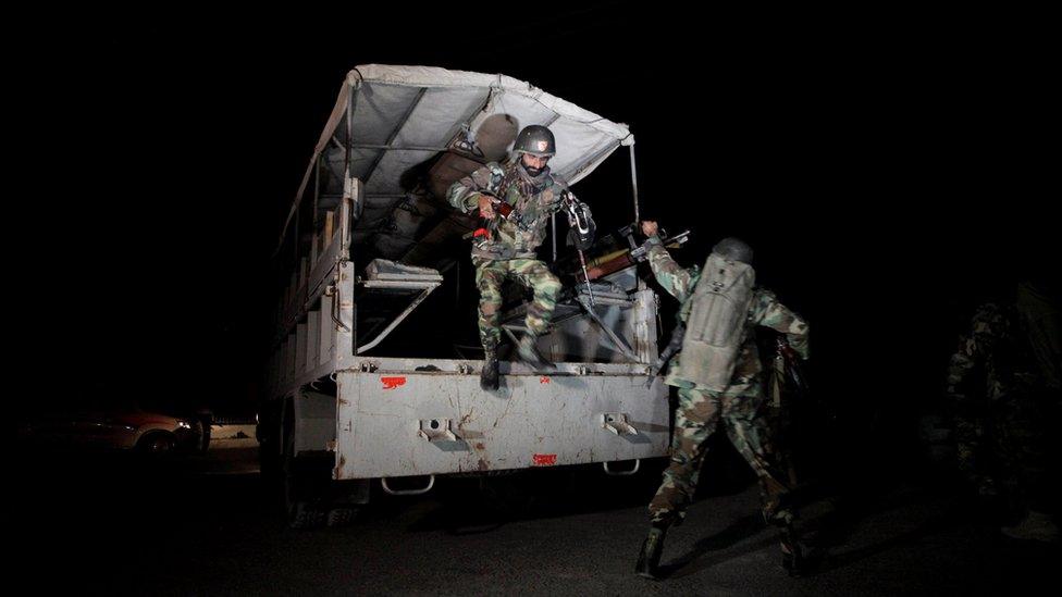 Pakistani troops jump from a vehicle outside the Police training centre, at night, during the Quetta attack in Pakistan on 25 October 2016.