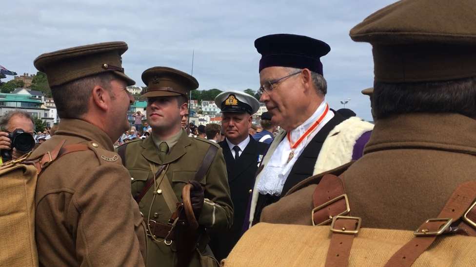 Guernsey's Bailiff Sir Richard Collas speaking to people in the parade