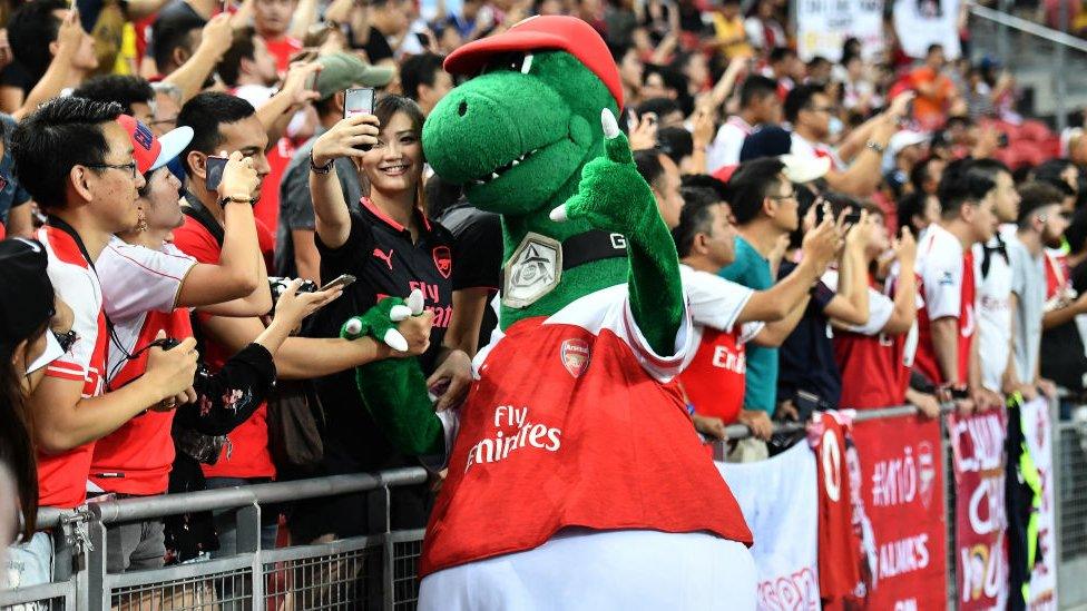 Gunnersaurus Arsenal mascot with fans in Singapore