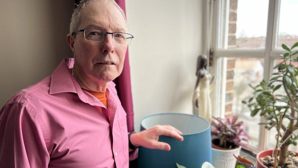 Resident Keith Sturgess stands by his Salisbury flat window