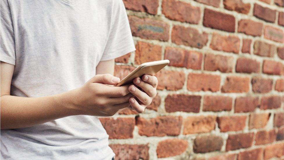 Teenage holding a phone