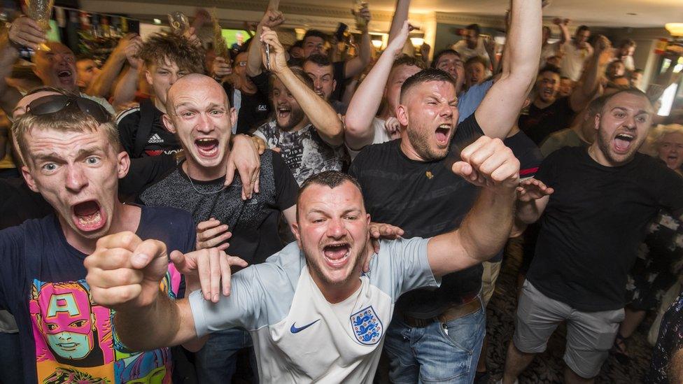 Fans celebrate inside a Manchester pub