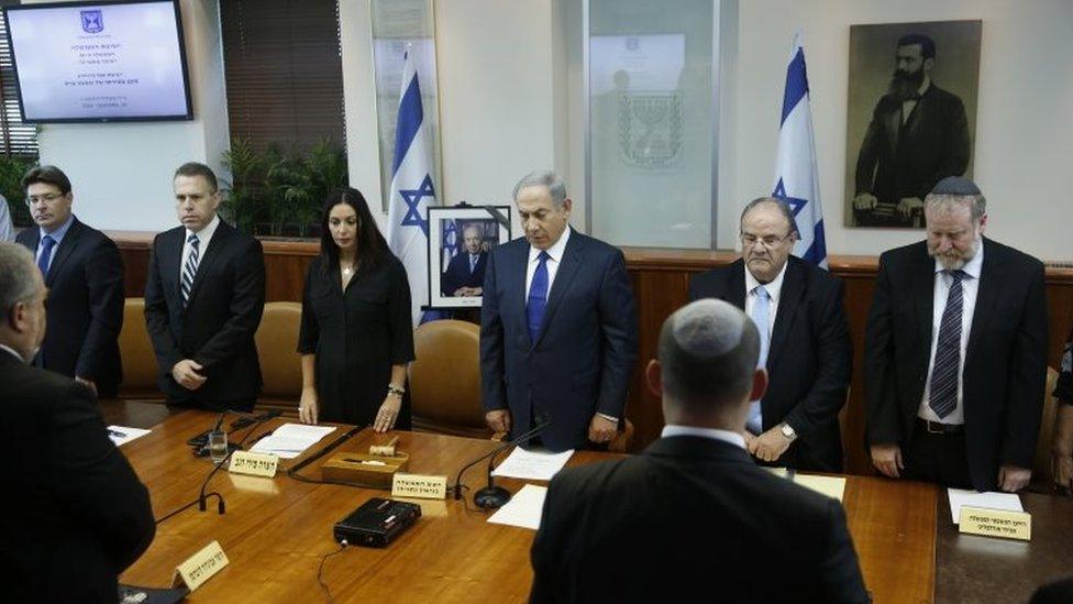 Israeli Prime Minister Benjamin Netanyahu, centre, and his cabinet ministers observe a moment of silence during a special cabinet meeting to mourn the death of former Israeli President Shimon Peres, in Jerusalem, Wednesday, Sept. 28, 201