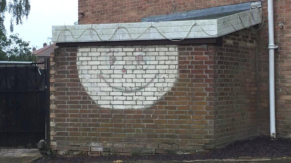 Smiley face on wall