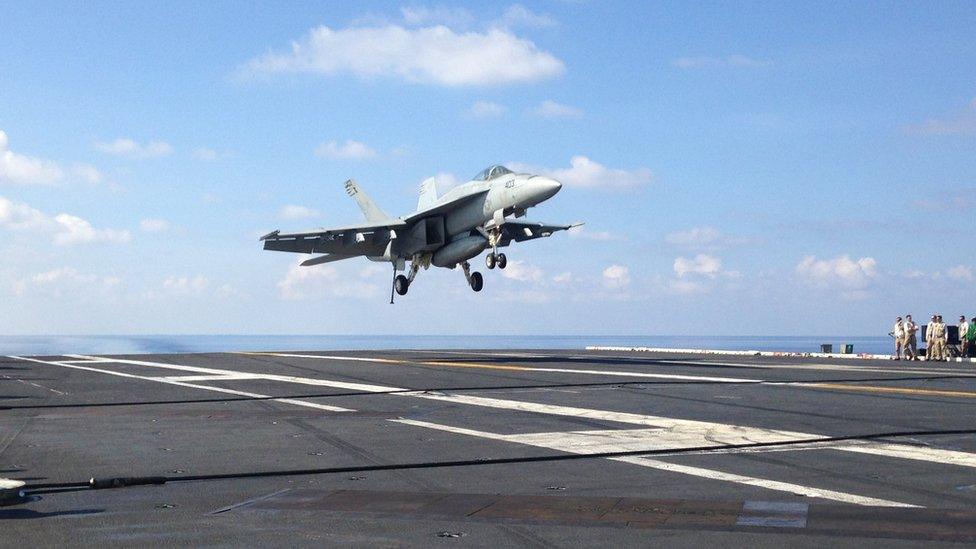 An FA-18 jet fighter takes off on the USS John C. Stennis, aircraft carrier in the South China Sea on Friday, April 15, 2016