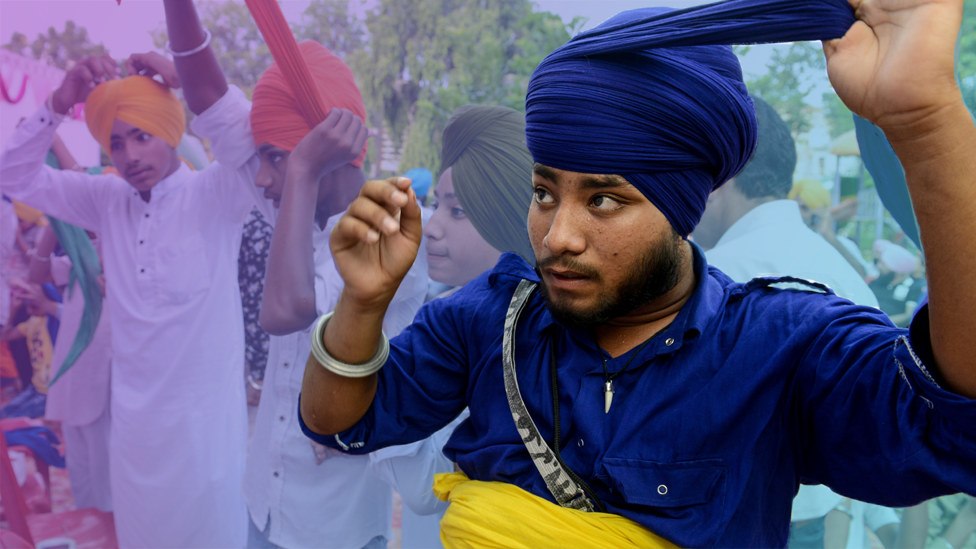 Young men wrapping turbans around their heads