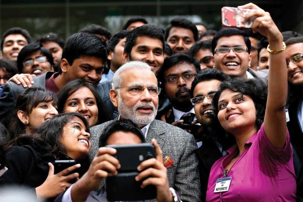 Prime Minister Narendra Modi takes a selfie with Indian employees during a visit to the Airbus facility in Toulouse, France, 2015