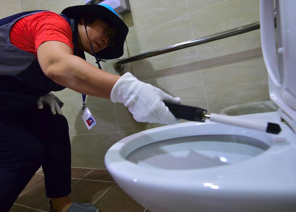 Seoul - checking toilet for hidden camera