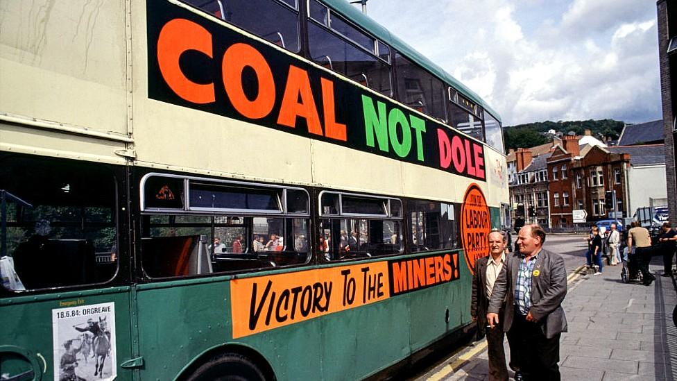 Bus with "Coal not dole" slogan on the side