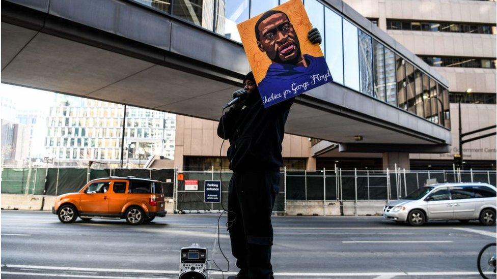 Demonstrator stands outside Hennepin County court