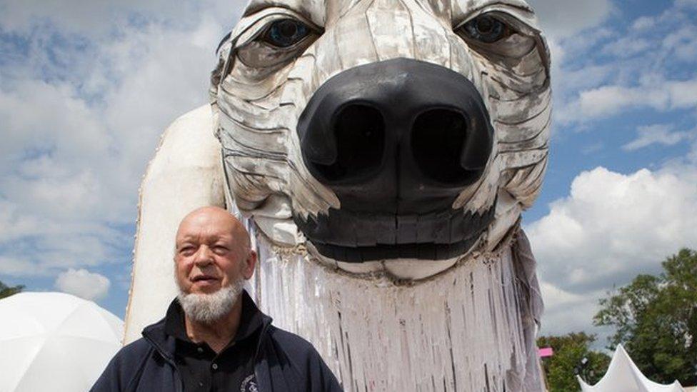 Michael Eavis in the Greenpeace Field, in front of the giant polar bear Aurora.