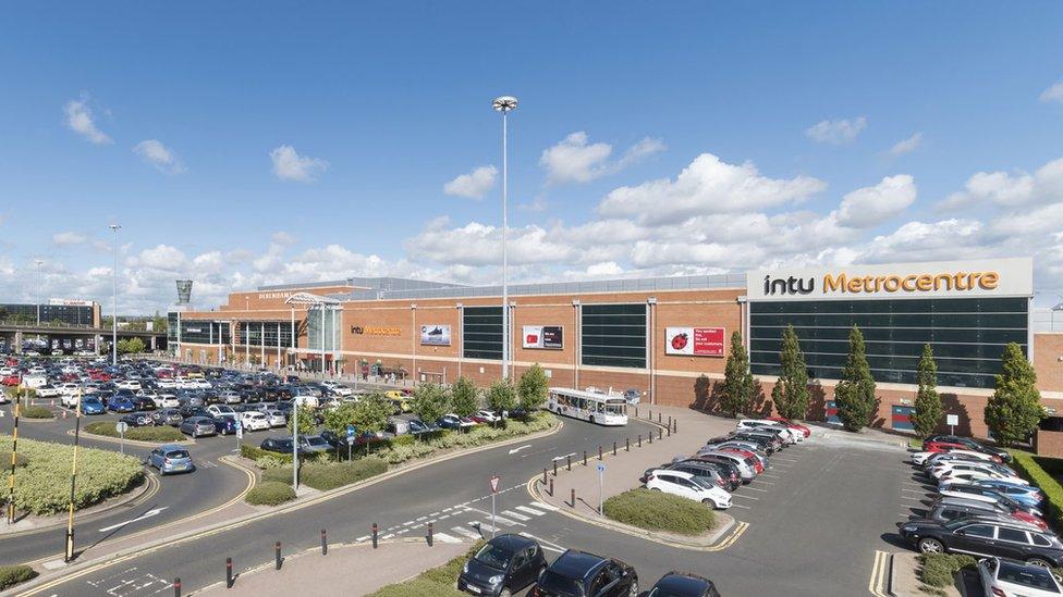 Exterior view of the Intu Metrocentre and a busy car park