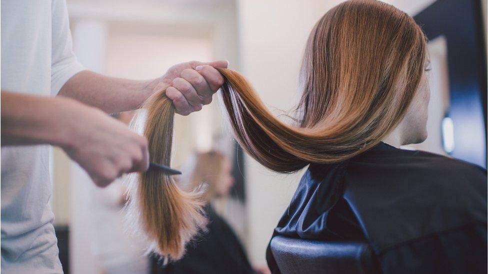 Woman getting haircut