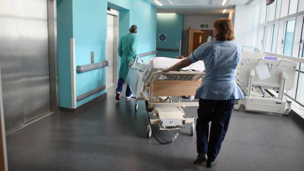 Staff push a trolley at the Queen Elizabeth Hospital in Birmingham