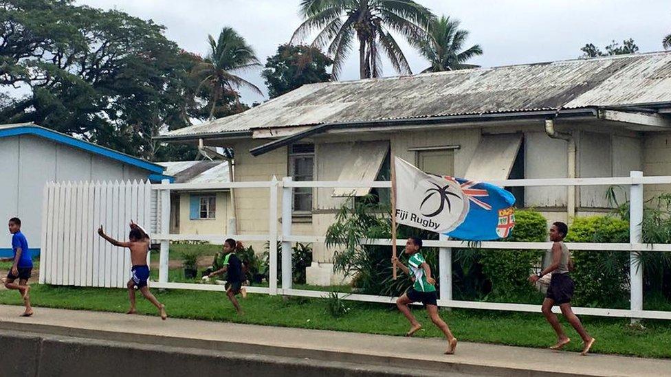 A group of boys celebrate in Fiji