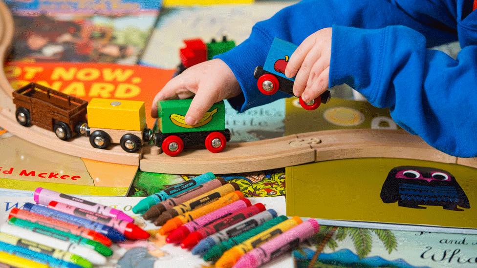 Child plays with toys