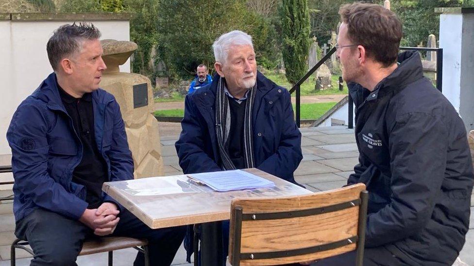 The Keepin family members chatting to Simon Bendry while seated at a table