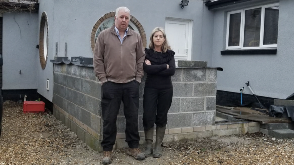 Sadie and Noel stood outside the building work