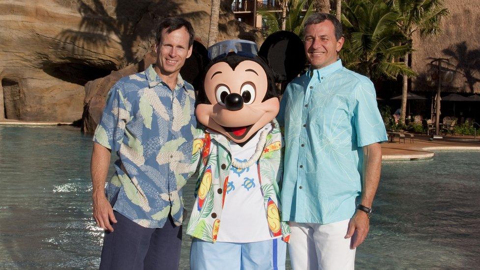 Left to right: Tom Staggs, Mickey Mouse and Bob Iger