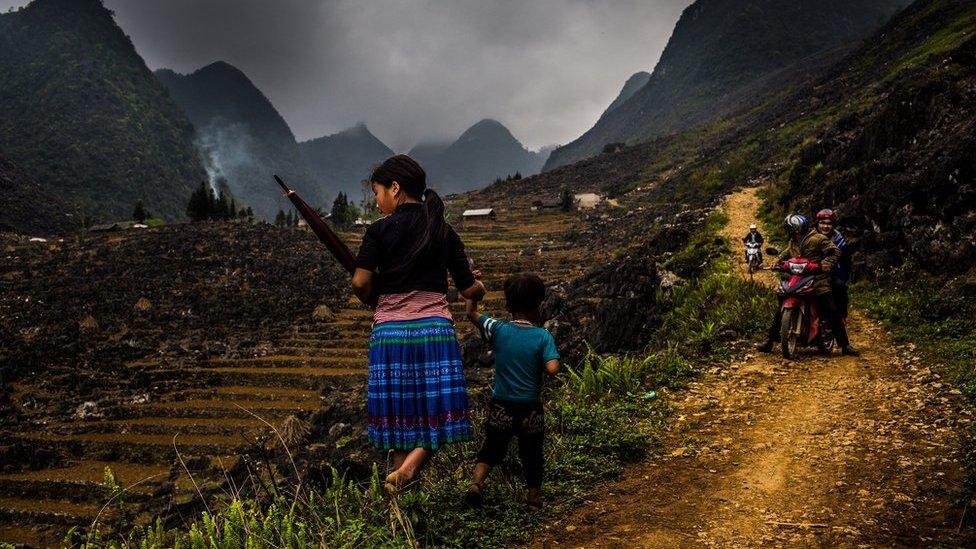 Children make their way through the landscape