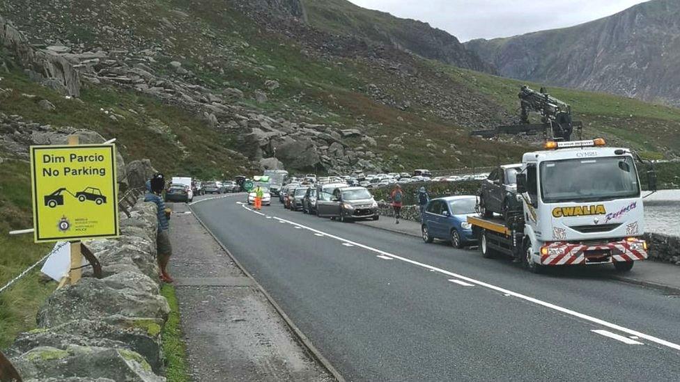 A vehicle is put on to a tow truck