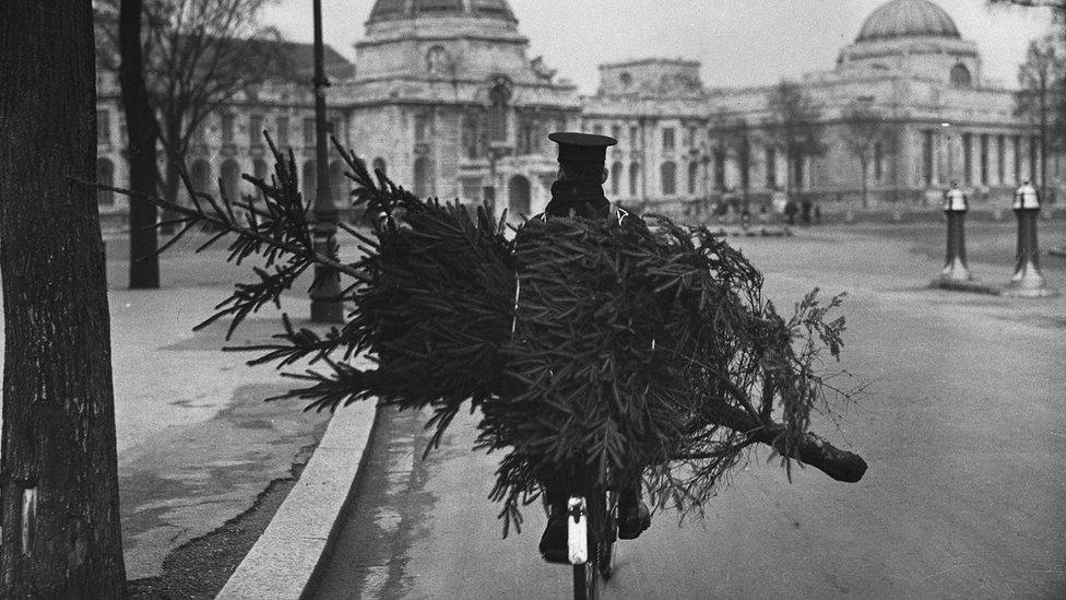 Postman with Christmas tree