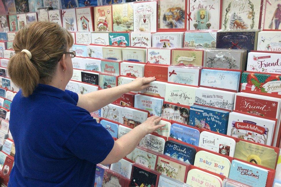 Shop manager sorting Christmas cards in Card Factory