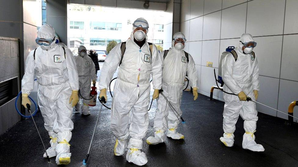 Health workers disinfecting a street