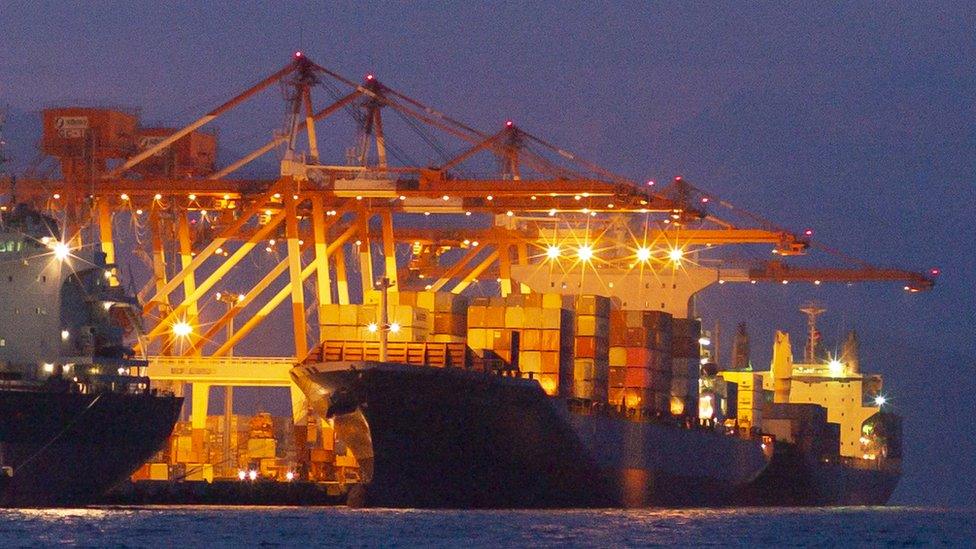 Cargo vessel being loaded at night