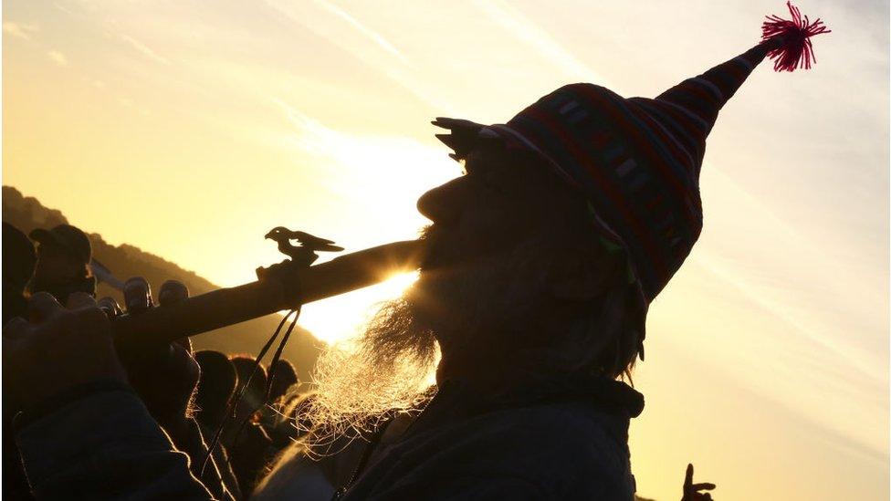 Man in hat playing pipe