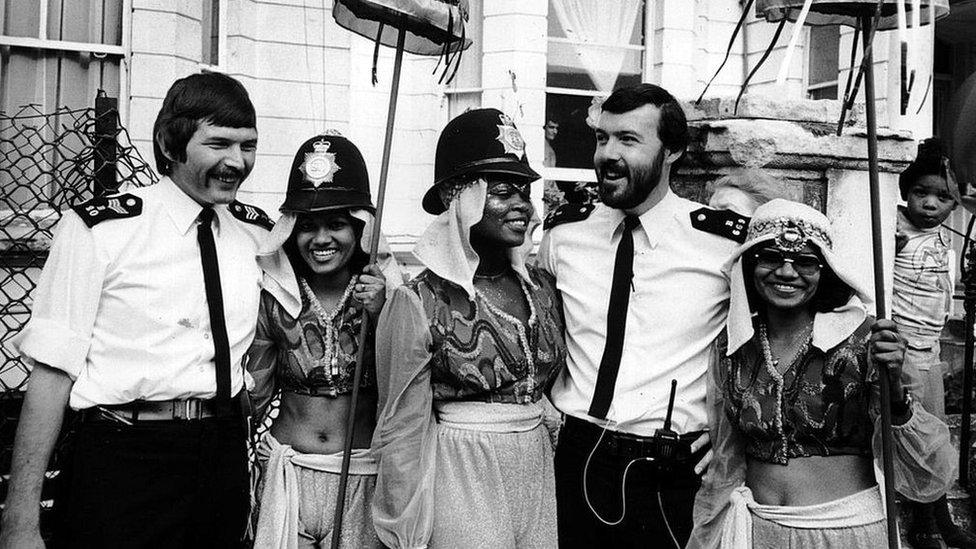 Police officers with Notting Hill Carnival performers in 1980