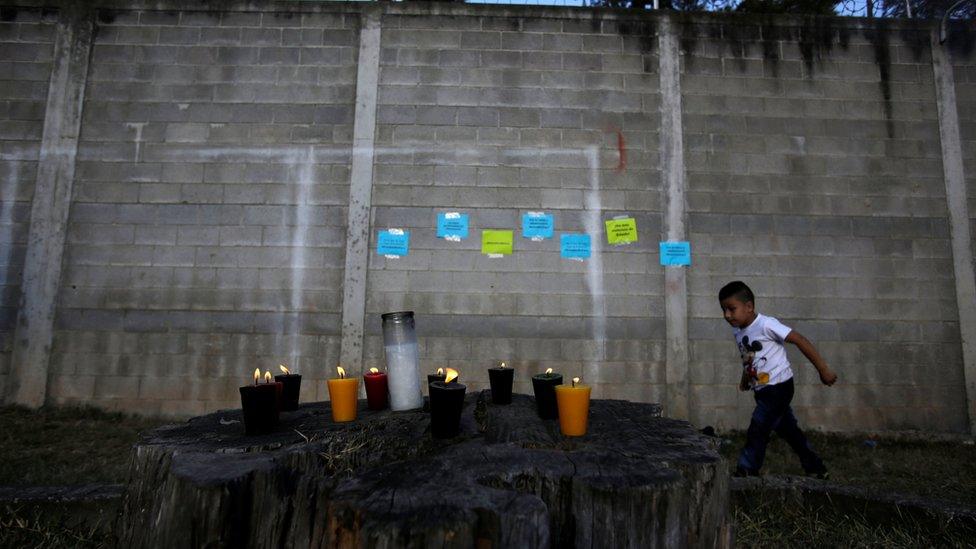 Candles are lit for victims after a fire broke at the Virgen de Asuncion home in San Jose Pinula on the outskirts of Guatemala City, March 8, 201