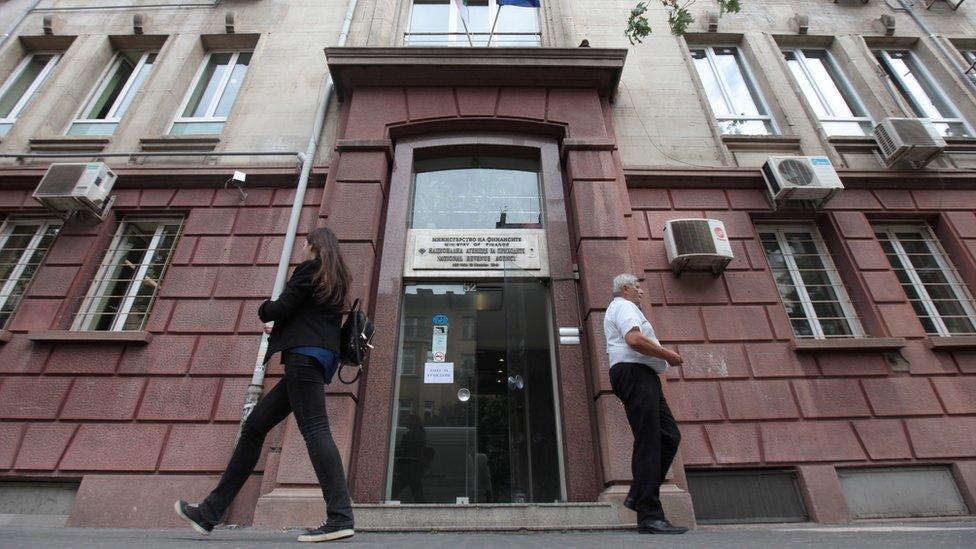 People walk past Bulgaria"s National Revenue Agency building in Sofia