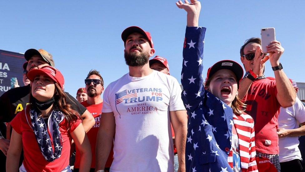 A girl raises a hand as she reacts during U.S. President Donald Trump"s campaign rally at Laughlin/Bullhead International Airport in Bullhead City, Arizona, U.S., October 28, 2020