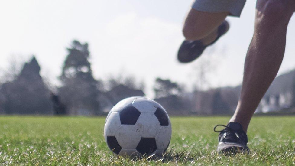 man about to kick football