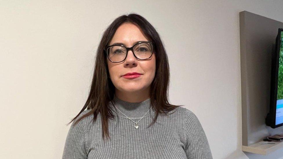 Woman with long straight hair and glasses