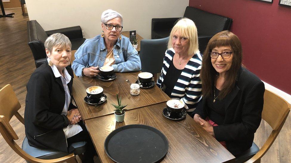 Four sisters around a coffee table