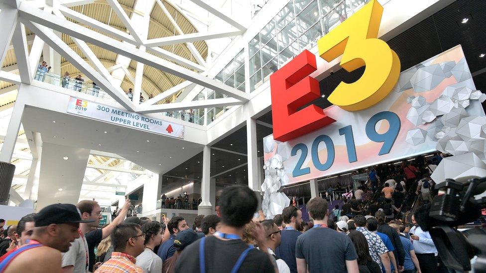 The E3 logo sits above a door as hundreds of attendees flow through the entrance into the conference centre