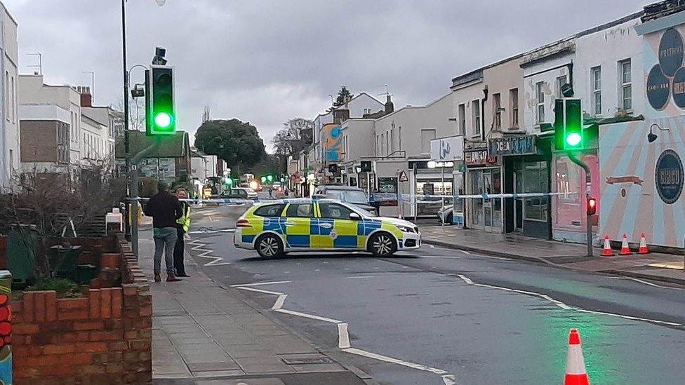 Police cordon in Cheltenham with a police car inside it