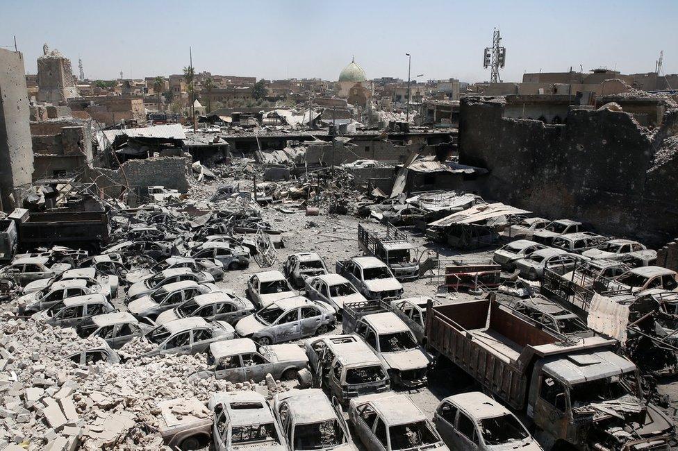 Remains of the destroyed Great Mosque of al-Nuri (background) and the al-Hadba minaret in the Old City of Mosul