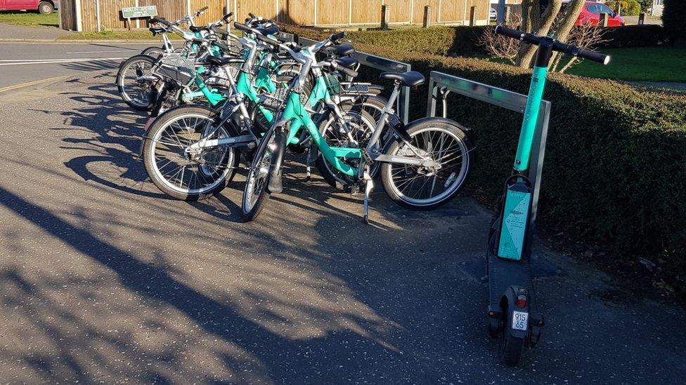 Beryl e-scooter and bikes in a bay on Wroxham Road, Sprowston, near Norwich