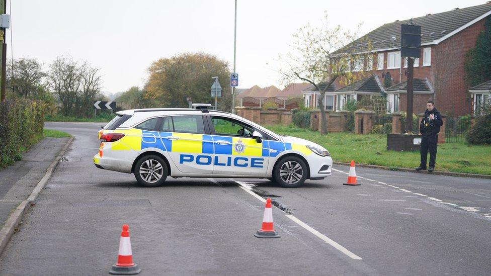 Police car at scene of bus crash