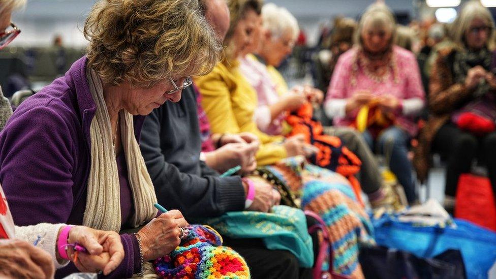 People crocheting at the event