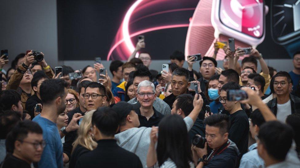 Tim Cook, centre, is mobbed during his visit to an Apple Store in Chengdu, China