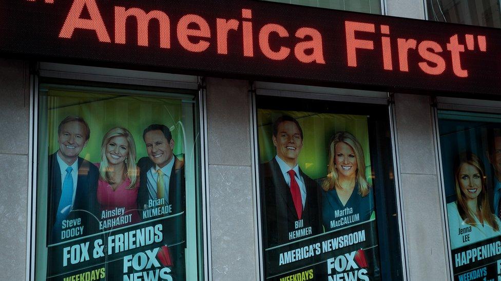 Posters are framed outside of the Fox News headquarters.