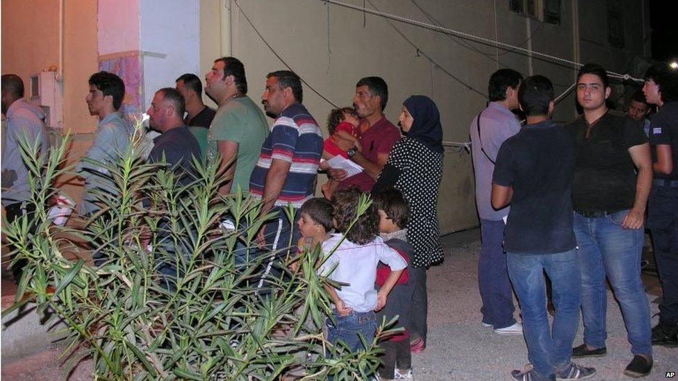 People who survived from a wreck wait to be registered by the local authorities at Lakki port on the southeastern Greek island of Leros, Sunday, Sept. 13, 2015