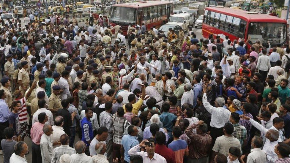 Members of India's low-caste Dalit community block traffic and shout slogans in Ahmedabad on Wednesday, July 20, 2016