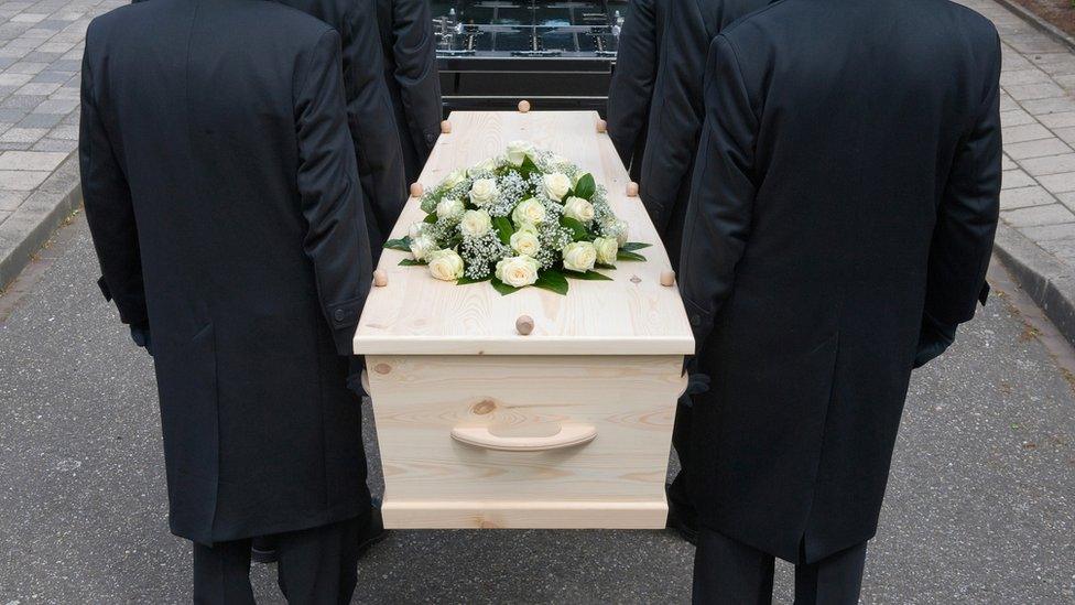 Pall bearers carrying coffin