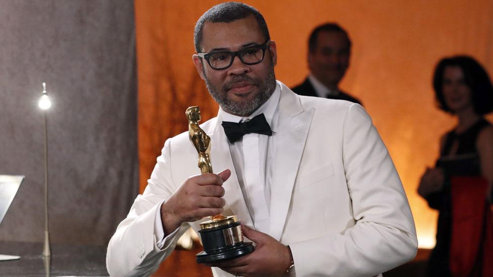 Jordan Peele with his Oscar