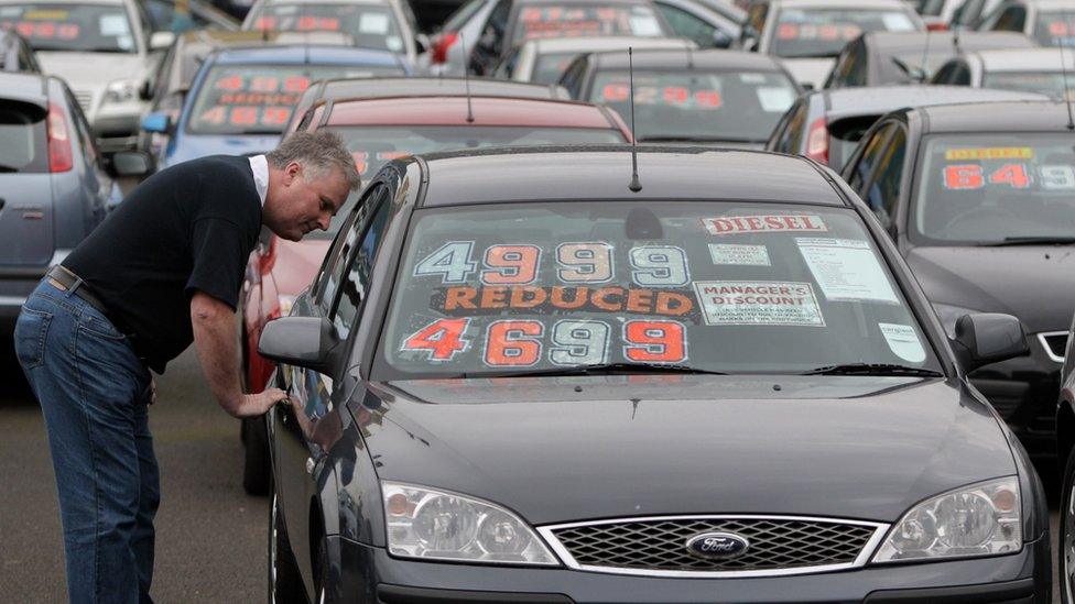 Man looking at car for sale